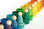Colourful wooden toy peg people, wooden rings and discs
