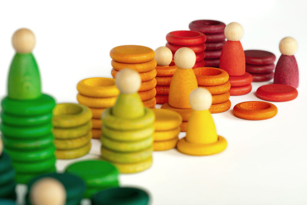 Colourful wooden toy peg people, rings and discs
