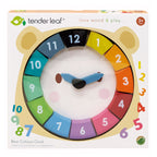 Box containing wooden bear clock with removable numbers and moving hands.